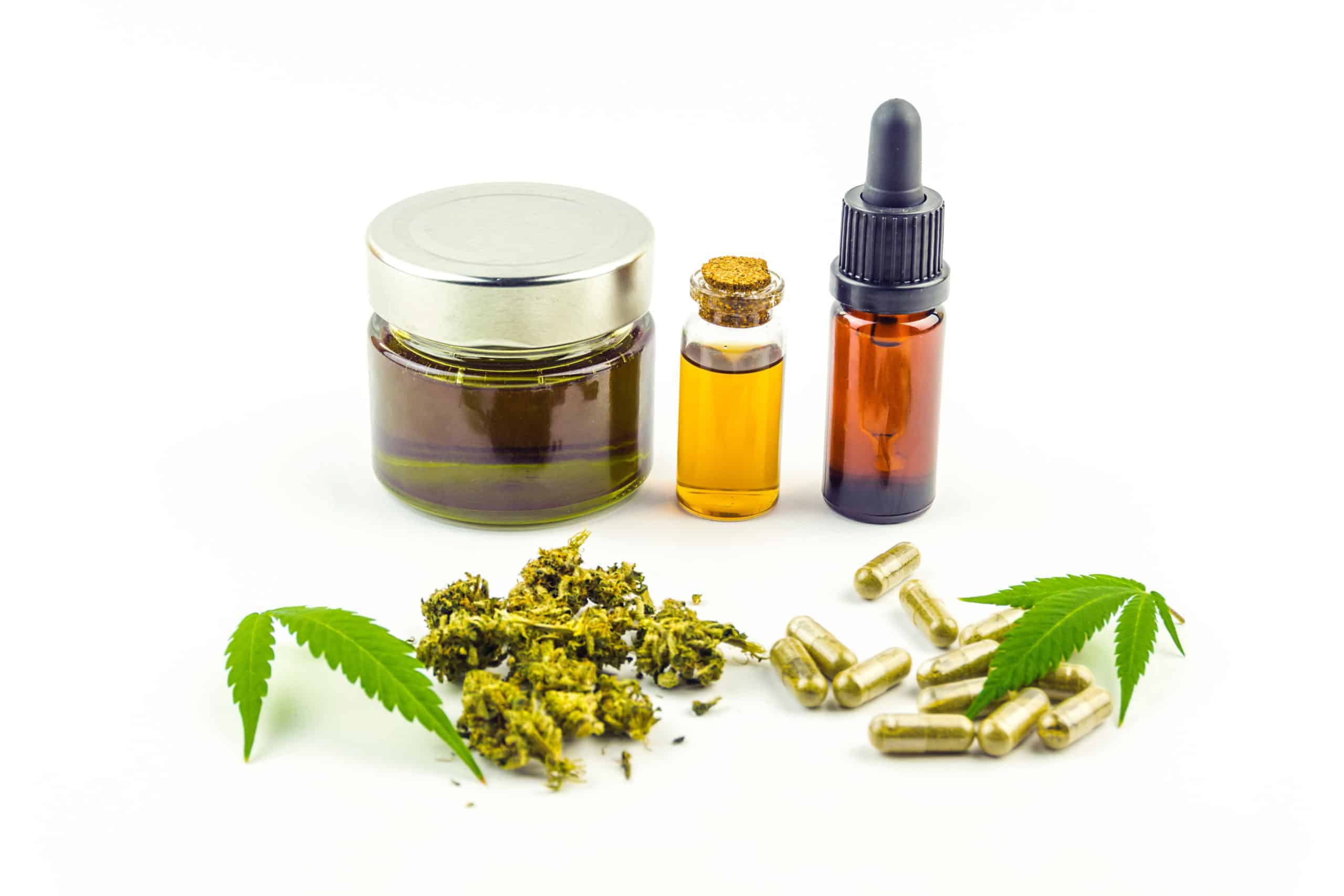 CBD cannabidiol oil glass bottles, pills flower buds and Cannabis leafs isolated